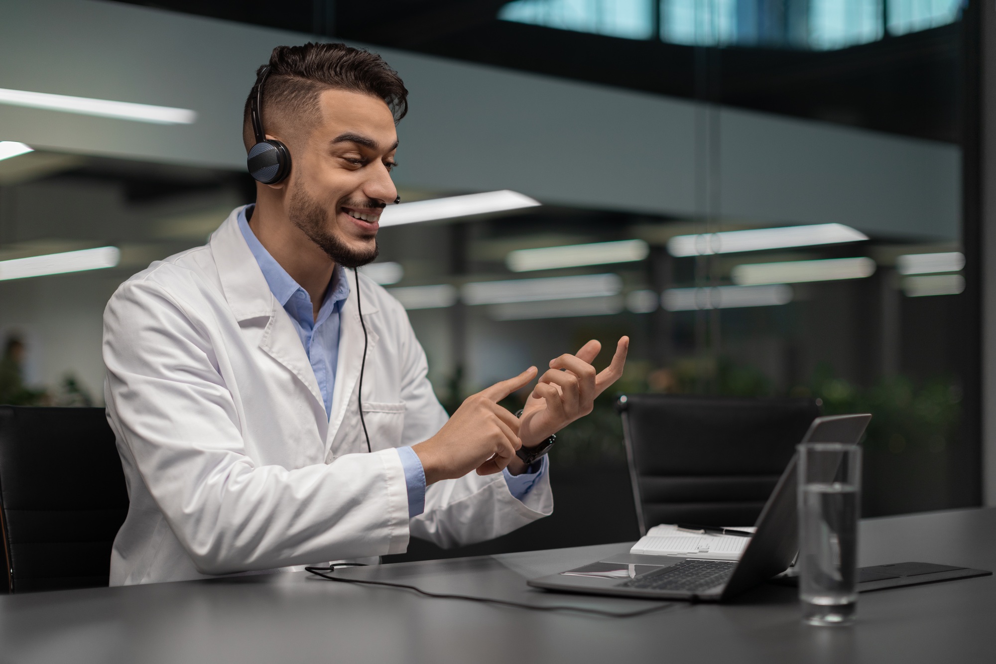 Handsome young middle eastern scientist using laptop at office